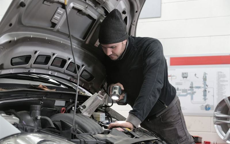 Mecánico revisando el motor de un auto
